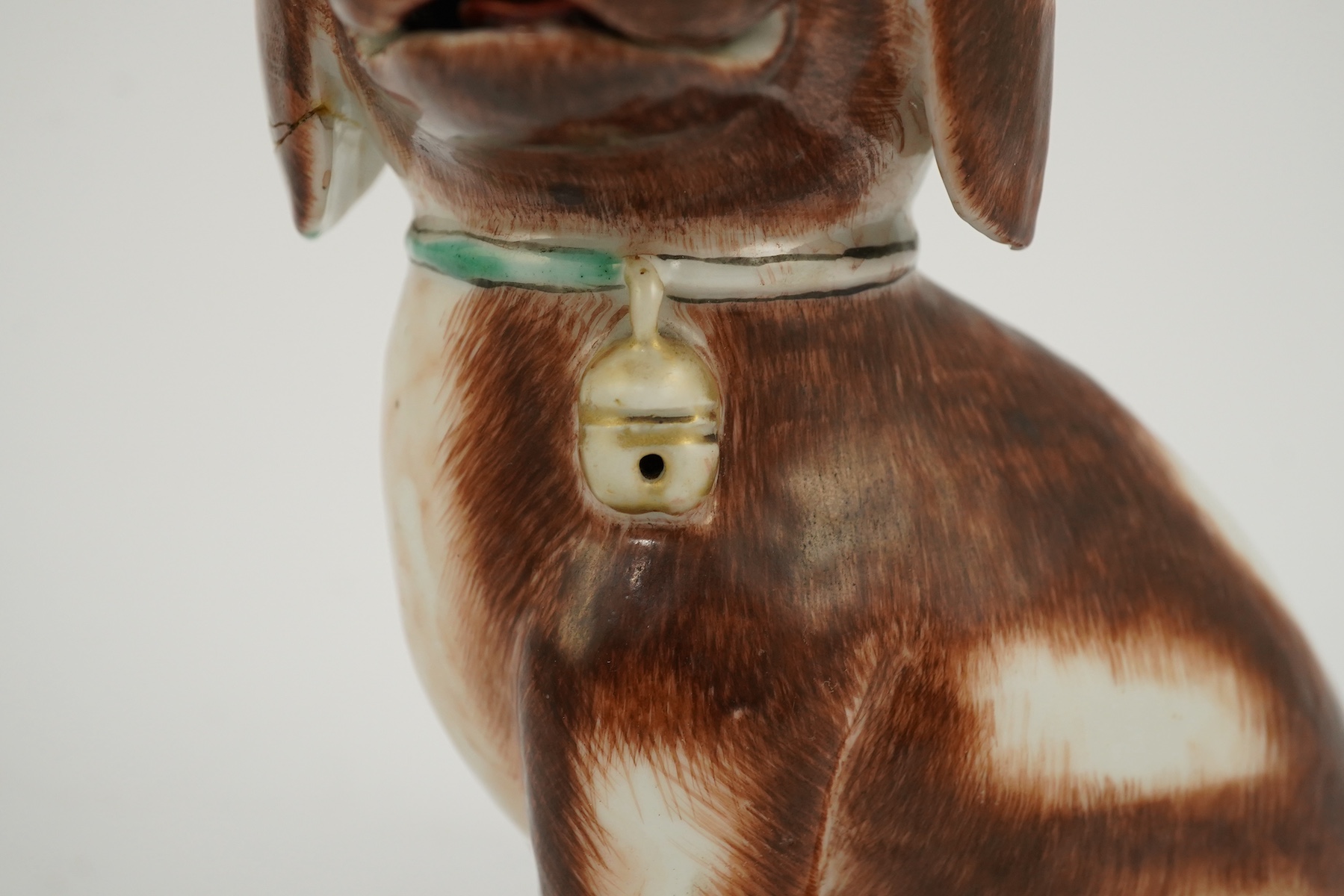 A Chinese export enamelled porcelain model of a seated spaniel, Qianlong period